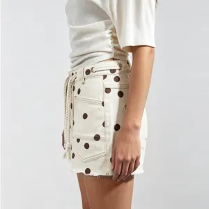 Women's polka dot denim shorts with braided drawstring and metal eyelets for chic casual style.