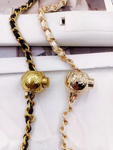 Detail shot of luxury style metal leather woven chain strap with classic quilted ball clasp.