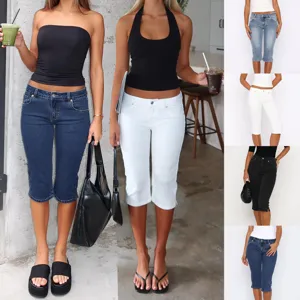 Women casual stretch denim capri pants detail view, showing slim fit and side split hem.