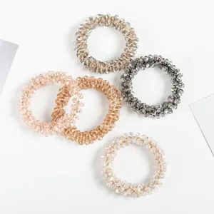 Close-up detail view of sparkling crystal beaded hair ties, elegant and stylish accessories.