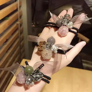 Accessorio per capelli a doppio uso in stile coreano con perle di cristallo e braccialetto.