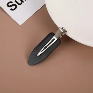 Minimalist matte black duckbill hair clip for makeup, styling, and fringe fixation.