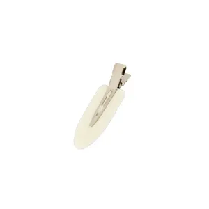 Closeup detail of the seamless duckbill hair clip with flat white pad for makeup styling.