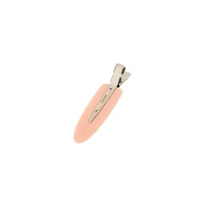 Close-up detail of the pink seamless duckbill hair clip, matte surface for daily makeup.