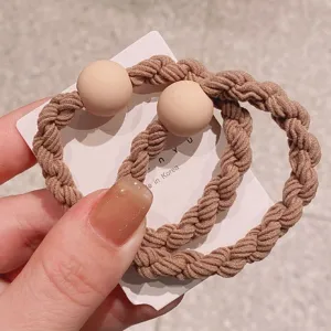 Detail view of thick braided hair ties with cute round beads for women daily ponytail styling.