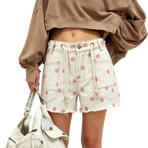 Women's polka dot denim shorts with chic braided drawstring and eyelet details, casual fit.