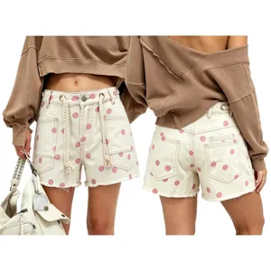 Detailed view of women polka dot denim shorts featuring drawstring waist and raw hem finish.