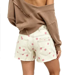 Detail shot of women's pink polka dot denim shorts featuring chic back drawstring eyelets design.