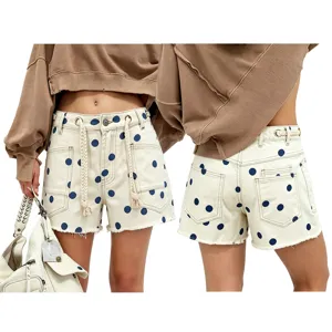 Detailed view of women's polka dot denim shorts featuring high waist and drawstring.