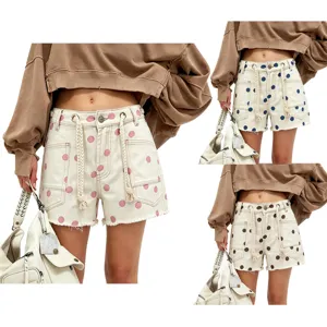 Close-up detail view of women's polka dot denim shorts featuring braided drawstring and pockets.