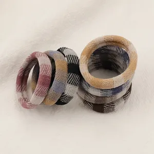 Seamless thick elastic hair ties in earth tone plaid designs, perfect for daily autumn styling.
