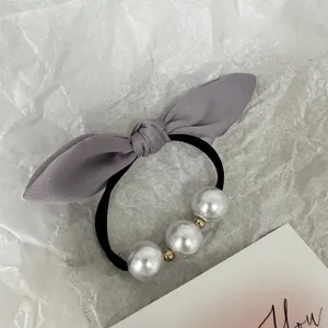 Chouchou perle noeud avec noeud en tissu gris, elastique a cheveux et design elegant pour femmes.