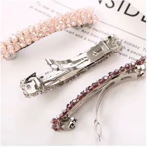 Detailed close-up of crystal beaded spring hair clips, handmade woven barrette with metal base.