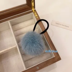 Cute fluffy pompom hair tie in milk blue, soft plush hair band for high ponytail styling details.