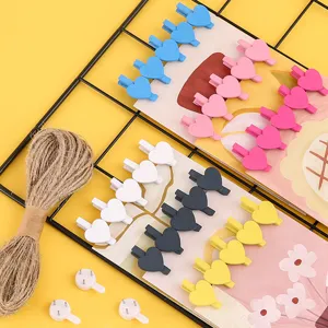 Colorful wooden heart clips set with jute twine and wall hooks for photo hanging and room decor.