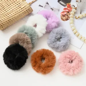 Fluffy plush hair scrunchies detail view, showing soft mink-like fur texture in multiple colors.