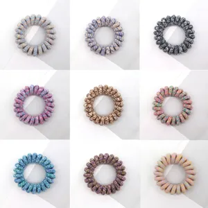 Detailed close-up showing multi-color fabric telephone wire hair ties with elastic rubber coils.