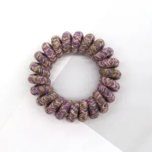 Close-up detail of vintage multi-color woven telephone wire hair tie, high elasticity.