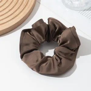 Brown satin hair scrunchie detail view, elegant shiny hair tie for styling and daily wear.