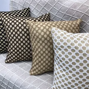 Detailed view of woven grid pattern decorative throw pillows for sofa and home living room.