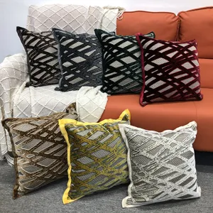 Detail view of luxury cut velvet throw pillows with modern geometric patterns for sofa decor.