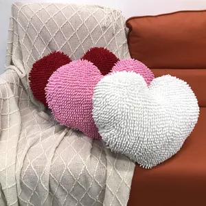 Heart-shaped shaggy plush cushion pillow detail, soft fluffy material for cozy home sofa decor.