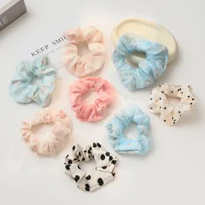 Detailed closeup view of assorted French sweet mesh and polka dot hair scrunchies set.