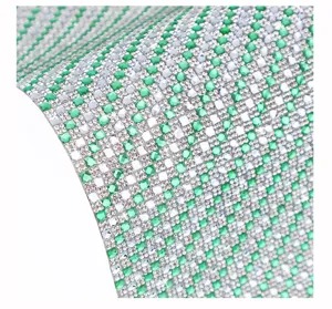 Close-up detail of self-adhesive green and silver rhinestone crystal sheet for DIY decor.