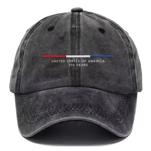 Close-up detail of the washed black baseball cap featuring red white blue embroidery and text.