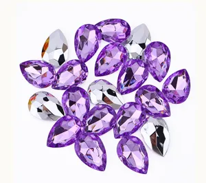 Close up detail of purple and silver teardrop acrylic rhinestones for DIY crafts and apparel.