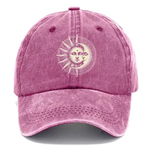 Berretto da baseball rosa lavato con stampa grafica sole e luna, dettaglio in primo piano all'aperto.