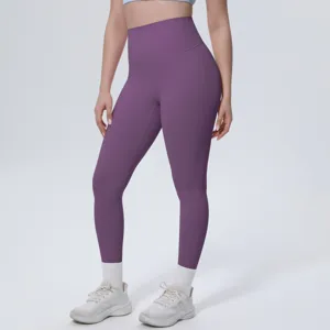 Detail shot of high-waisted purple yoga pants worn by model, showing fitted silhouette and fabric.