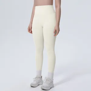 Detail shot of women high waist solid color yoga pants in beige, soft breathable fitness fabric.