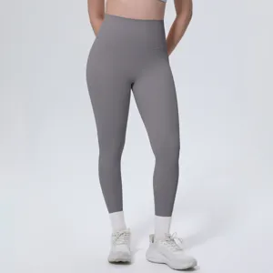 Close-up detail of women's high-waisted solid grey yoga leggings, soft stretch fabric.
