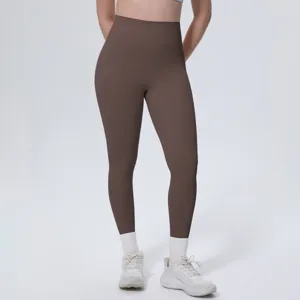 High-waisted brown yoga pants detail view, showing smooth fabric texture, slim fit and stitching.