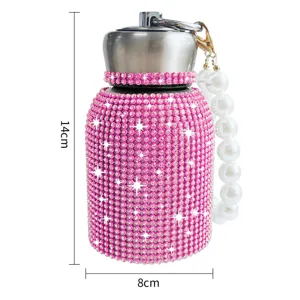 Pink rhinestone insulated water bottle detail with pearl handle and stainless steel lid.