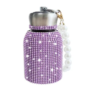Detailed view of the sparkling purple rhinestone thermos cup featuring an elegant pearl carrying strap.