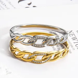 Silver and gold rhinestone intertwined metal bracelets detail, elegant chic fashion jewelry item.
