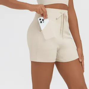 Beige athletic shorts detail, high waist, drawstring, practical side pocket for phone.