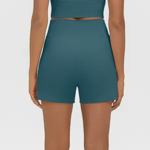Back view detail of high waist teal athletic shorts and crop top set for fitness training.