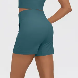 Dark teal high waist fitness yoga shorts detail view with side pockets for activewear.