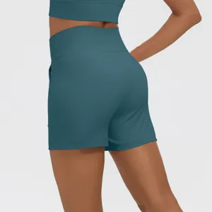 Close-up back view of teal high-waisted fitness shorts with practical side pockets.