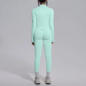 Vista dettagliata del top sportivo a maniche lunghe senza cuciture e leggings verde menta.