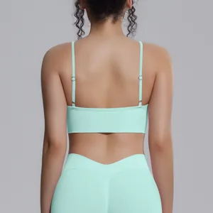 Back view of a seamless mint green yoga crop top and leggings set, showing adjustable straps.