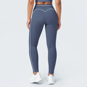 Leggings de yoga azules de talle alto con costuras en contraste blancas y diseño moldeante.
