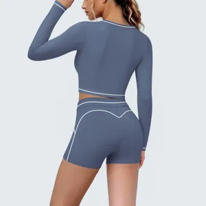 Long sleeve yoga top and shorts set in dusty blue with white contrast piping details for active sports.