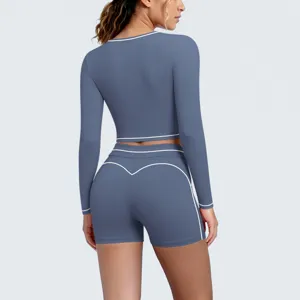 Detail view of the greyish-blue long sleeve crop top and shorts activewear set for women.