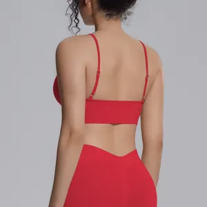 Back detail view of a red seamless sports bra and leggings set, showing adjustable straps.