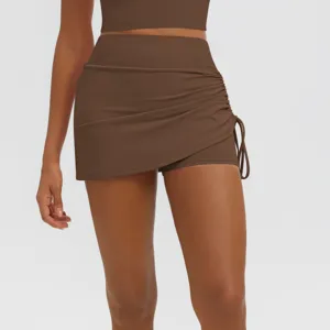 Brown ruched fake two-piece yoga skort detail, high waist athletic running fitness skirt design.