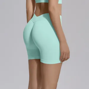 Close-up back view of high-waisted seamless mint green yoga shorts, peach butt-lift design for fitness.